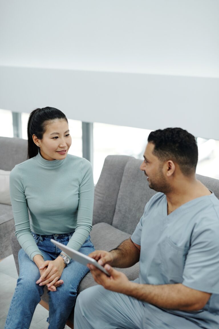 A Doctor in Scrubs Performing A Well Woman Health Check On A Patient